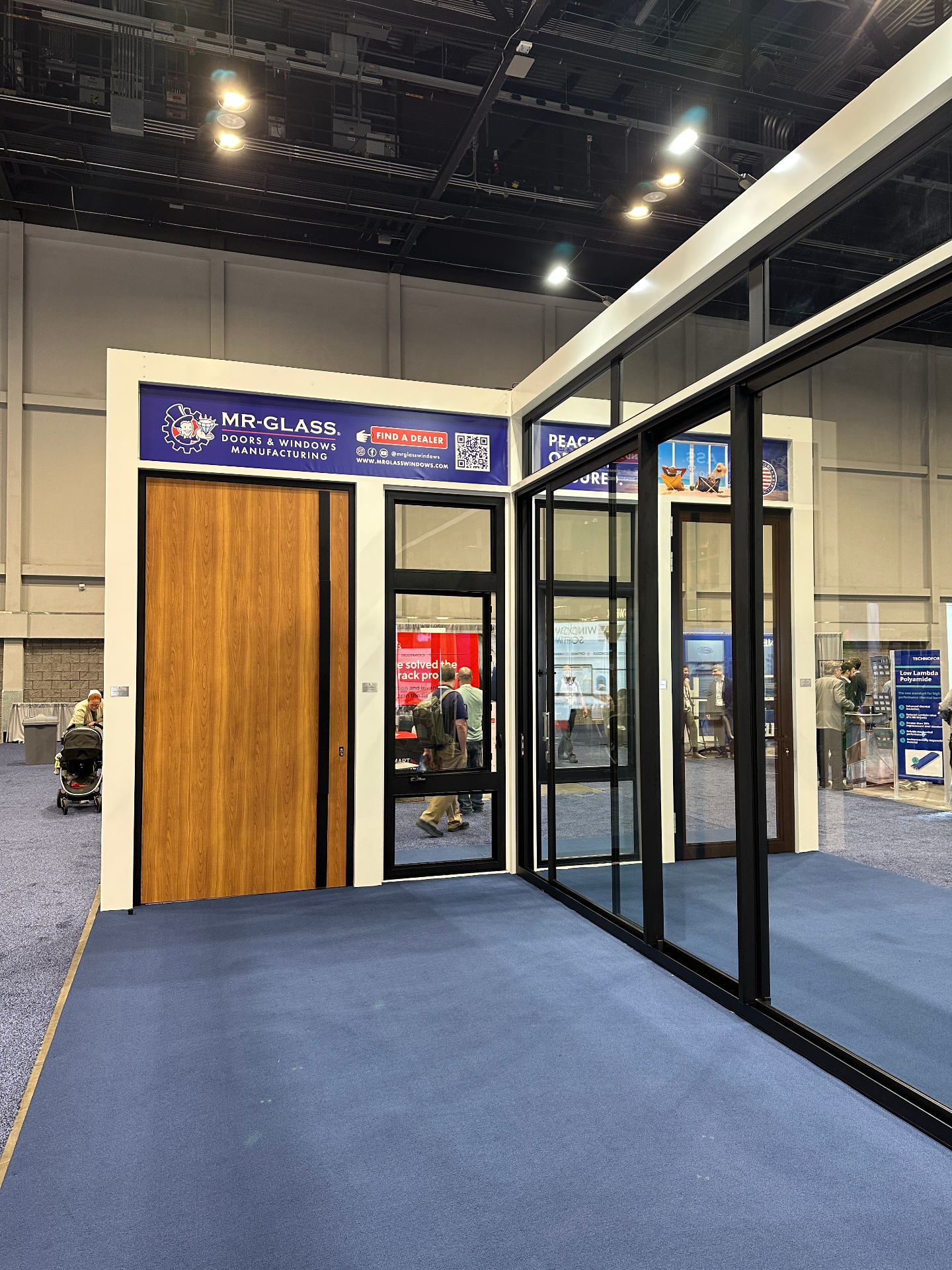 MR-Glass doors and windows booth at SEBC 2025 showcasing 12-foot high impact-rated entry doors and sliding glass systems